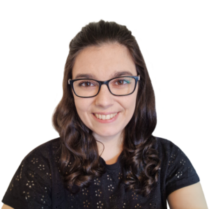 Headshot of smiling woman with black-framed glasses and brunette hair.