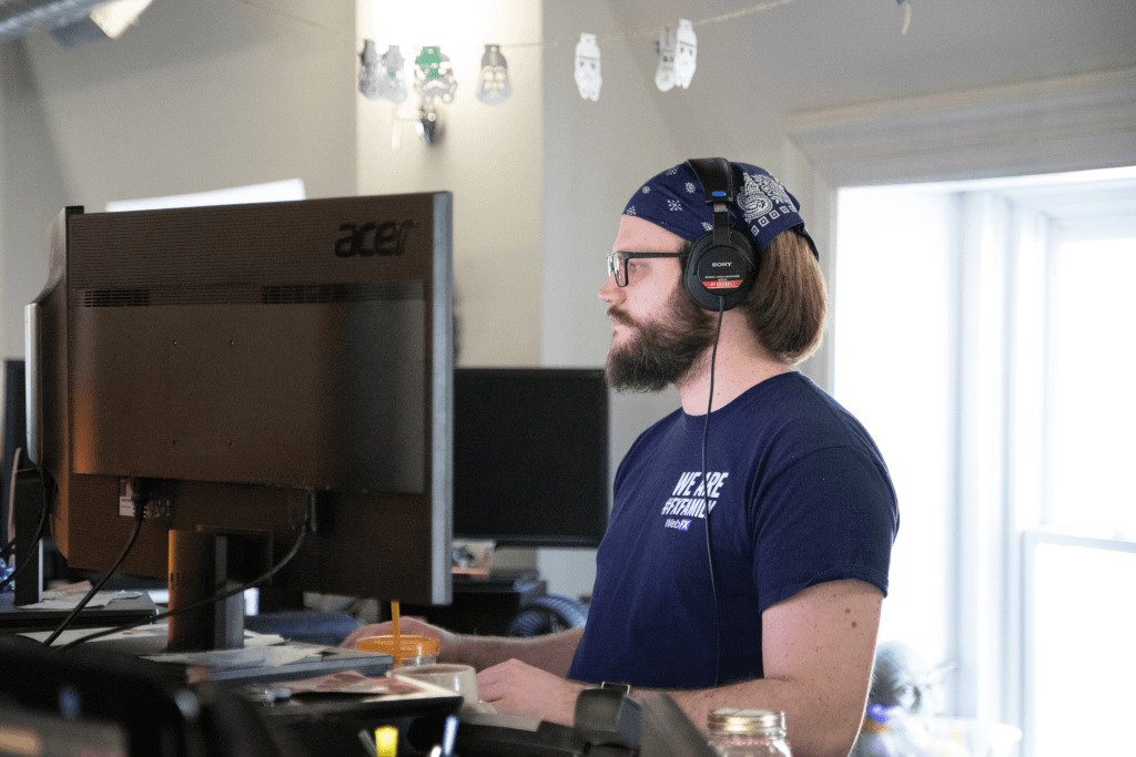 a man wearing headphones and a blue shirt that says we are #FXfamily